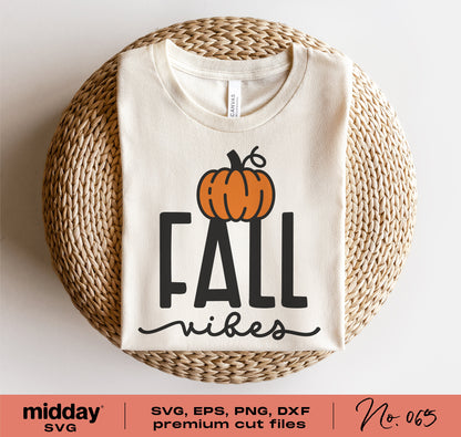 Folded beige shirt with 'Fall Vibes' and pumpkin graphic, showcasing SVG cut file for Cricut or Silhouette, perfect for autumn crafting.
