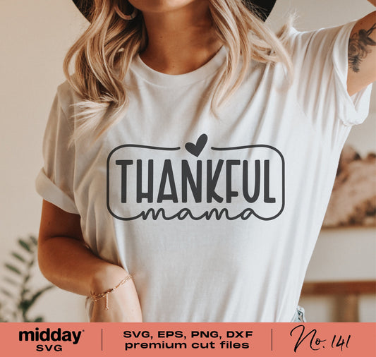 Woman wearing a white t-shirt with 'Thankful Mama' SVG design, ideal for Thanksgiving or fall apparel crafting projects with Cricut or Silhouette.