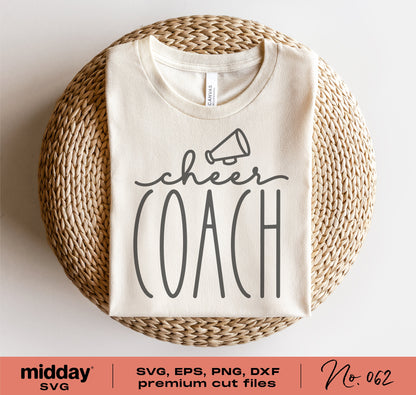 White cheer coach shirt with megaphone design folded on wicker basket, available in SVG, PNG, DXF, EPS formats for Cricut and Silhouette.