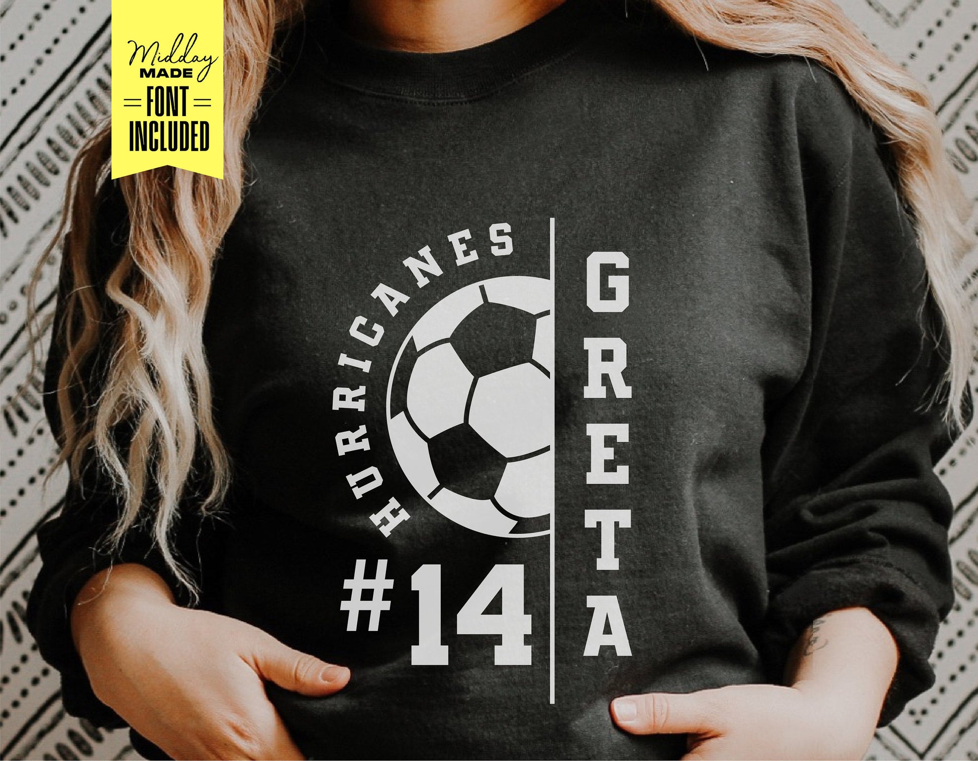 Person wearing a black soccer shirt with a custom design, including the team name 'Hurricanes,' player name 'Greta,' and number '14'.