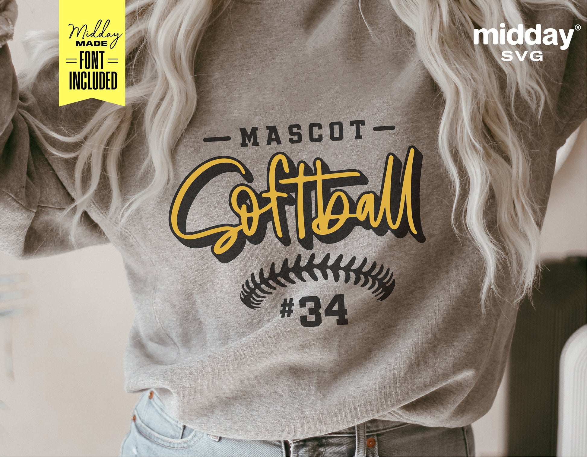 Woman wearing sweatshirt with customized softball team logo showing 'Mascot Softball #34' design in yellow and black.