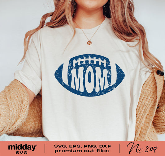 Woman wearing a shirt with a blue football and 'MOM' graphic, showcasing a design for SVG, PNG, DXF, and EPS cut files.