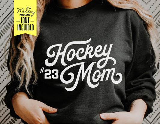 Black sweatshirt with 'Hockey Mom #23' in white script font.