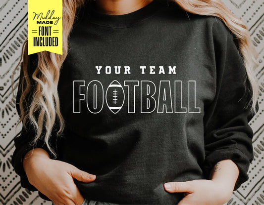 Person wearing a black sweatshirt with 'Your Team Football' printed in white letters, designed for sports fans and personalization.
