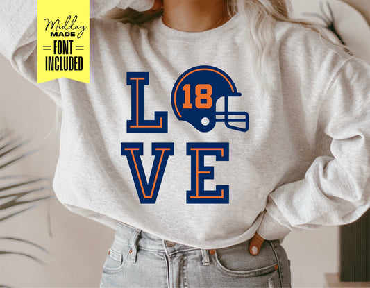 Person wearing a gray sweatshirt with 'LOVE' design featuring a football helmet for Cricut and Silhouette projects.
