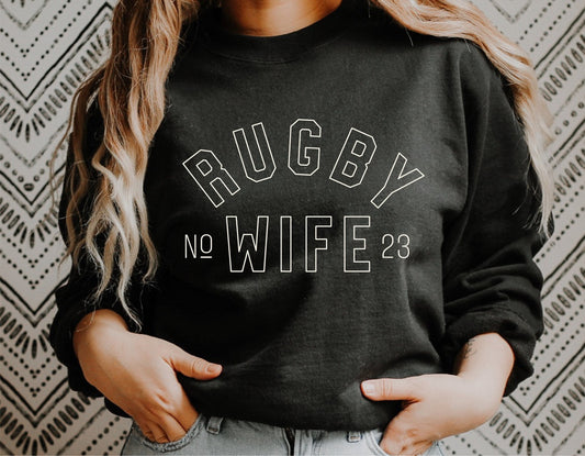 Woman wearing black sweatshirt with 'Rugby Wife' design, ideal for Cricut, sublimation, and crafting projects, perfect for rugby fans.