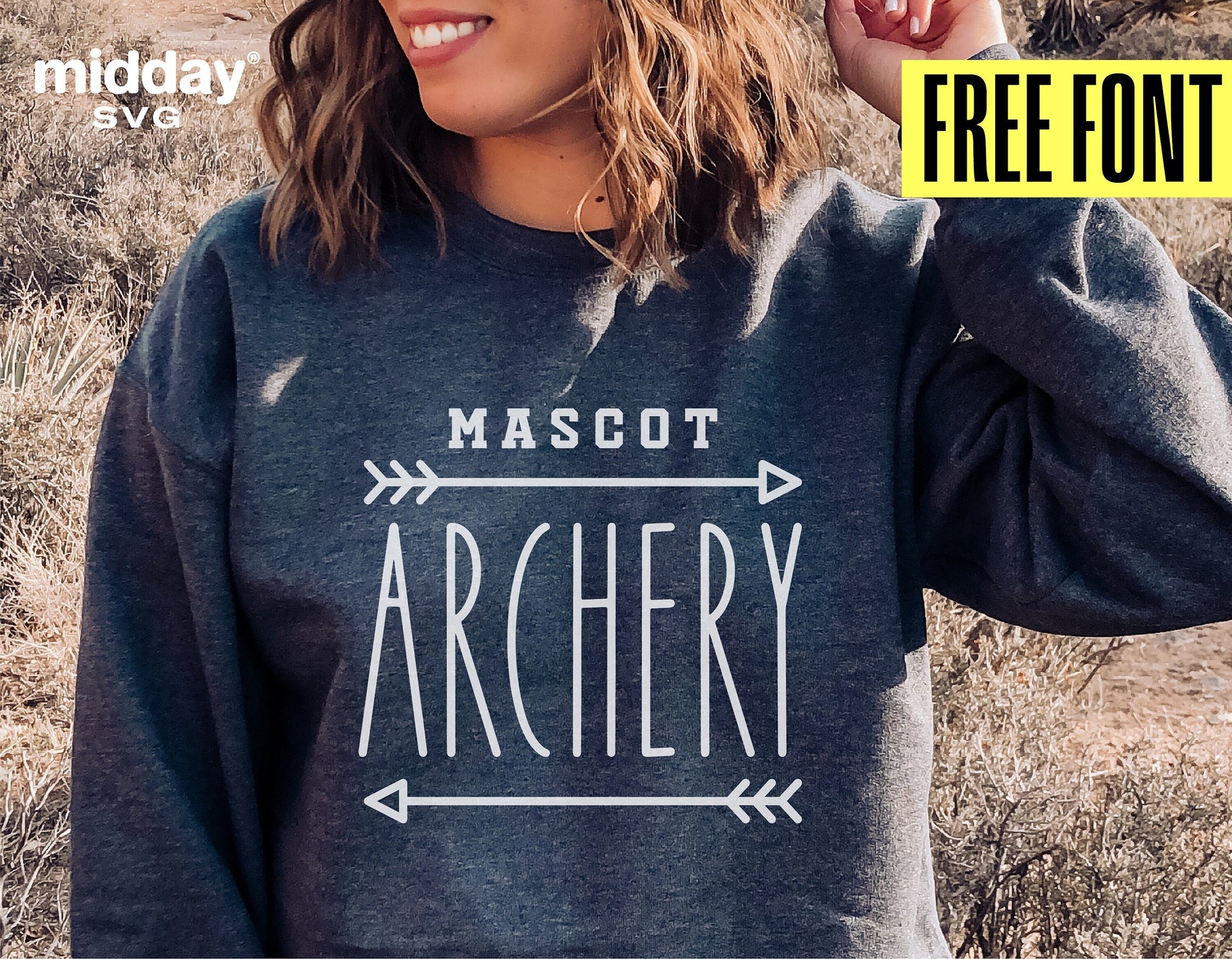 Woman wearing sweatshirt with 'Mascot Archery' design in field, featuring offer for free font.