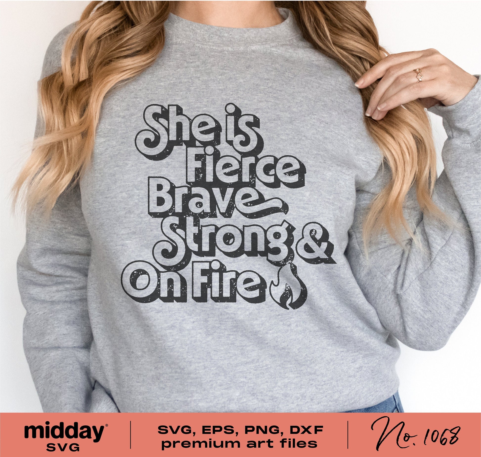 Woman wearing a gray sweatshirt with 'She is Fierce Brave Strong & On Fire' text, featuring a feminine empowerment design.
