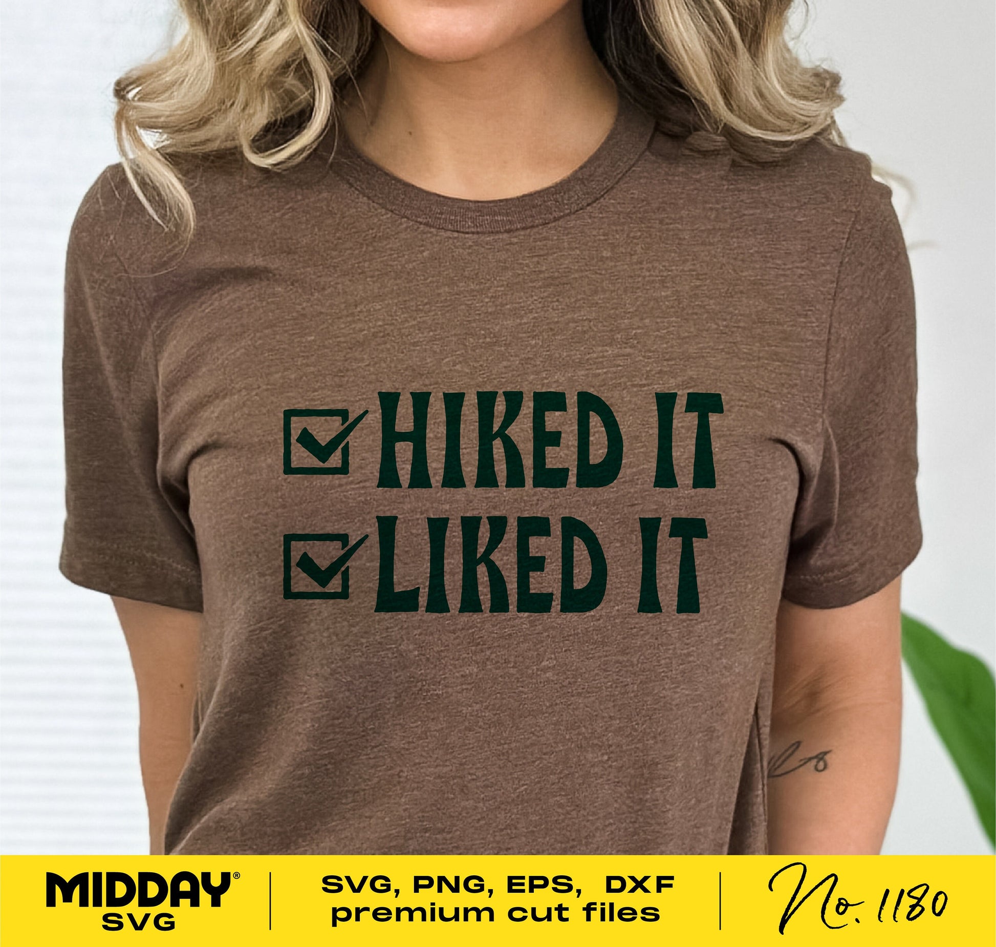 Woman wearing a brown t-shirt with 'Hiked It Liked It' text design, suitable for Cricut and Silhouette projects.