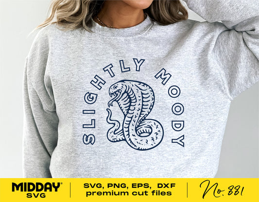 Woman wearing a gray sweater with 'Slightly Moody' sarcastic SVG design, featuring a snake graphic. Suitable for Cricut and Silhouette projects.