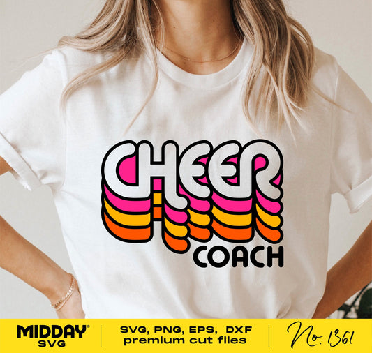 Woman wearing a shirt with colorful 'Cheer Coach' graphic design, featuring retro-styled text in orange, pink, and white.