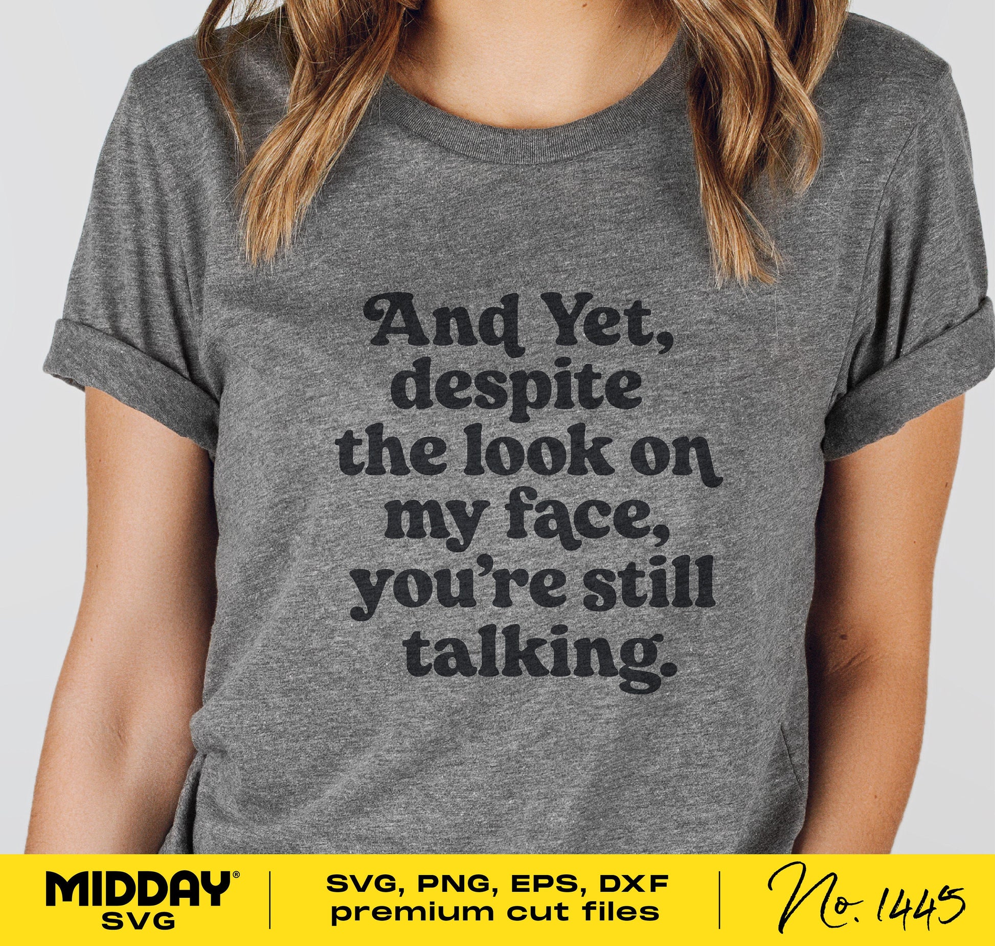 Gray t-shirt with the phrase 'And yet, despite the look on my face, you're still talking' in black font, humorous and sassy design.