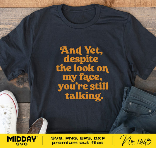 Black t-shirt with "And Yet, despite the look on my face, you're still talking" text, surrounded by casual shoes and jeans