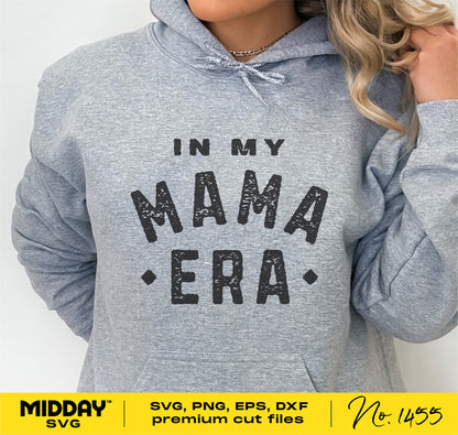 Woman wearing gray hoodie with "In My Mama Era" print, showcasing SVG design for Cricut and sublimation, perfect for mom-themed projects.