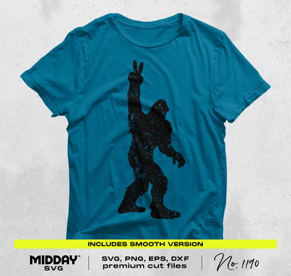 Blue t-shirt featuring a Bigfoot silhouette with a peace sign, part of an SVG and PNG bundle for outdoor and crafting projects.