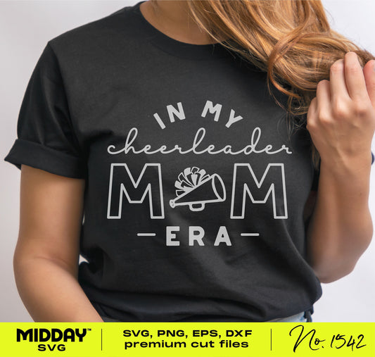 Person wearing a black t-shirt with 'In My Cheerleader Mom Era' and a megaphone design, promoting cheer mom SVG files.
